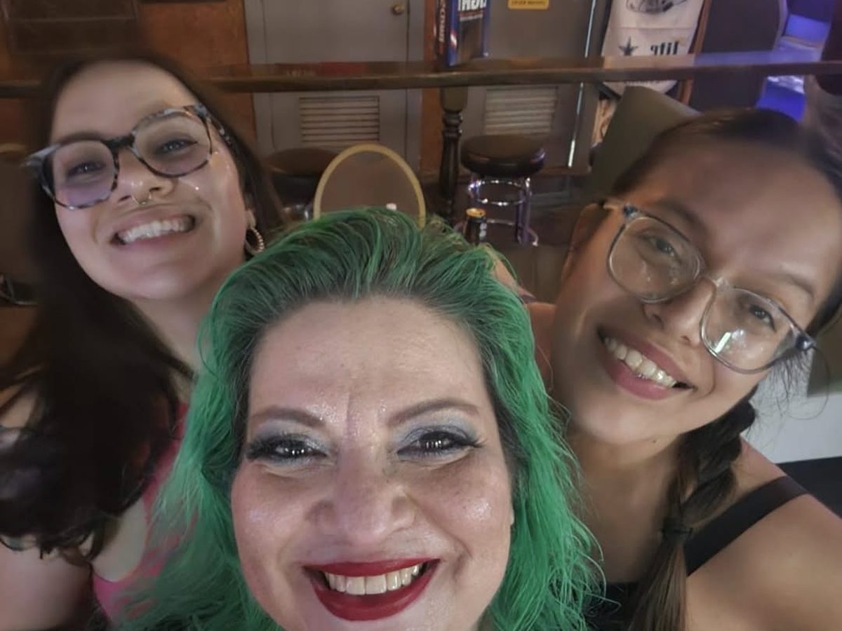 Mia and two friends smiling together for a selfie at Midtown
