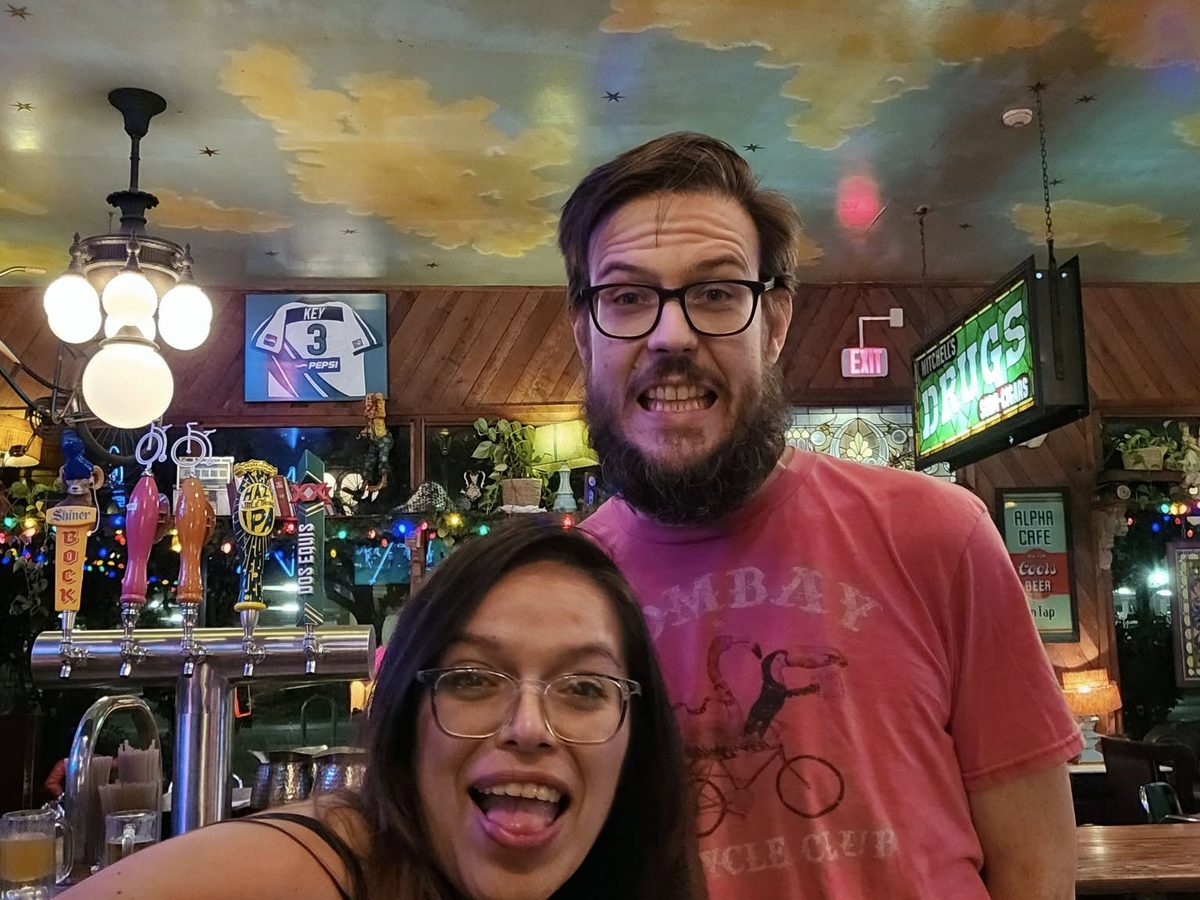 Mia and a friend clowning for the camera at the bar
