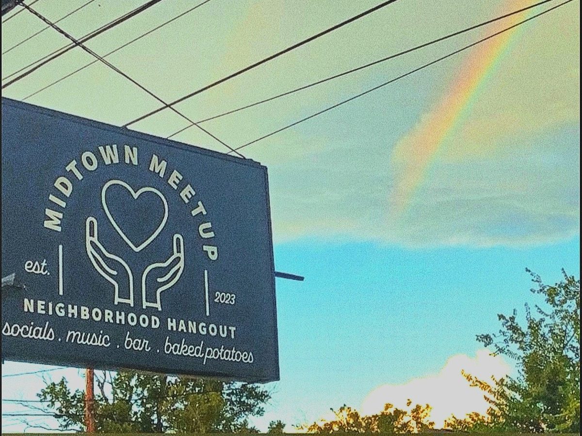 The Midtown Meetup sign under a rainbow
