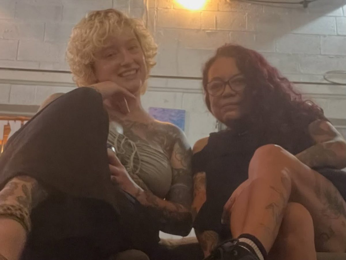 Mia and a friend relaxing together on a couch at Midtown