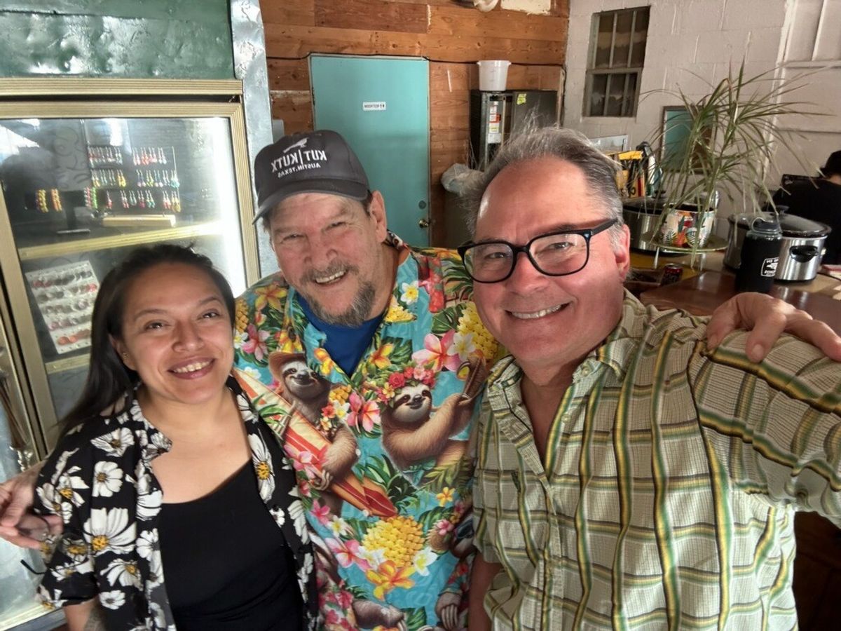 Mia with two friends in bright Hawaiian shirts inside Midtown