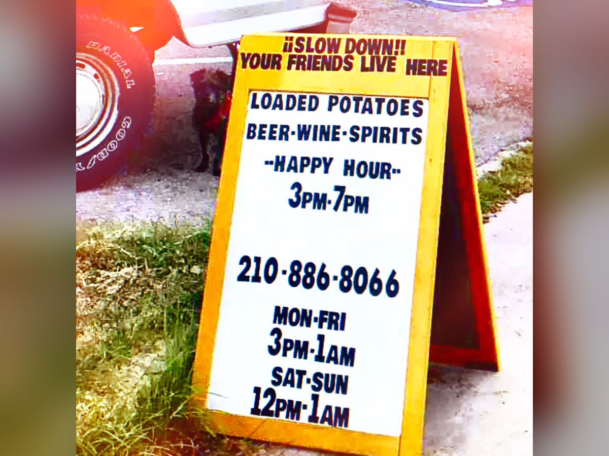 The Midtown sidewalk sign listing loaded potatoes and happy hour